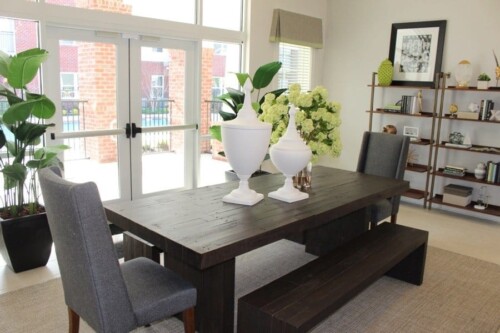 Clubhouse dining table and bench at Clairmont at Campostella Station Apartments