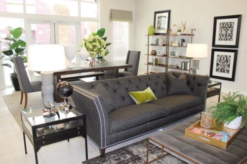 Clubhouse lounge with sofa and bookshelves at Clairmont at Campostella Station Apartments