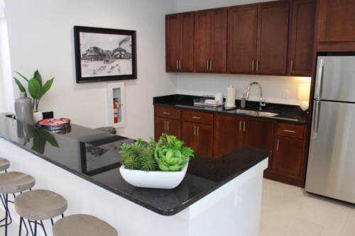 Clubhouse kitchen with bar seating at Clairmont at Campostella Station Apartments